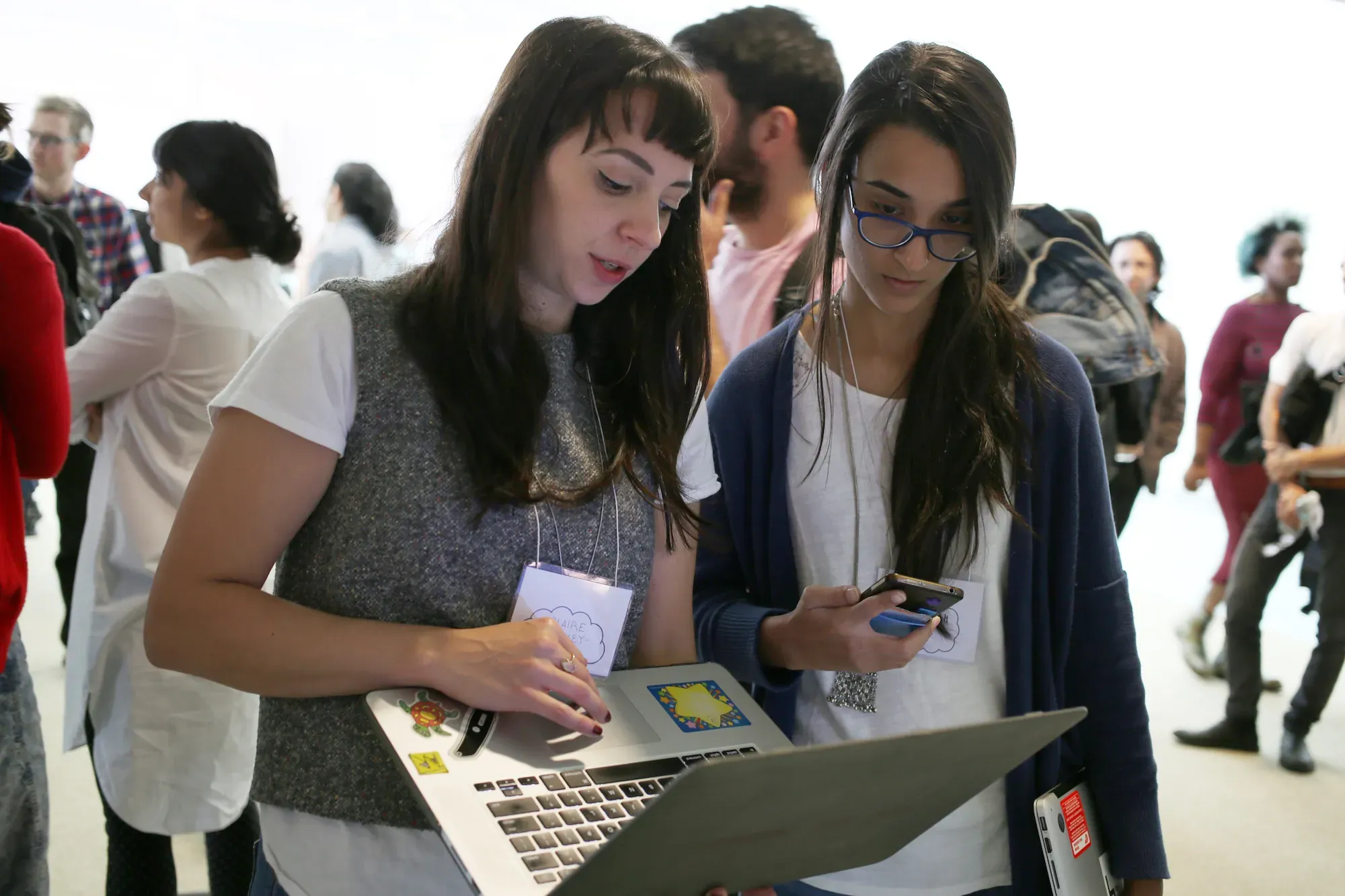Two participants looking at a laptop during a demonstration at PCD Boston