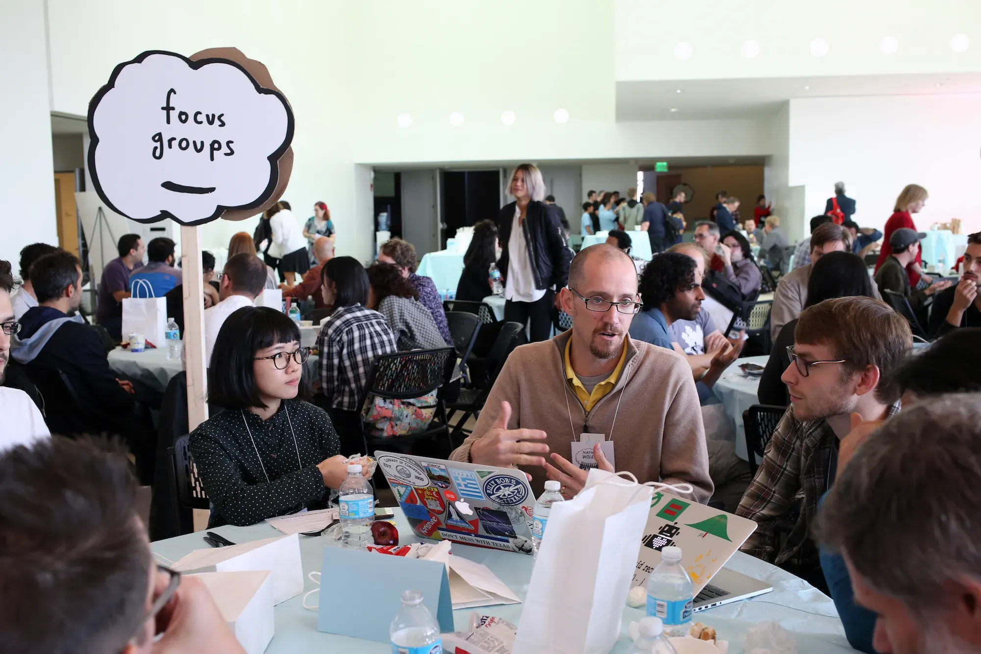 Participants gathered around tables for small-group conversations at PCD Boston